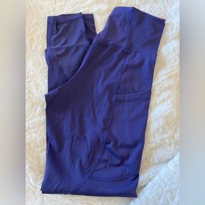 Purple leggings with side pockets and mesh on calves
